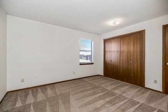 1339 Westbrooke St, Lawrence, KS 66049 - unfurnished bedroom featuring carpet floors, a textured ceiling, baseboards, and a closet