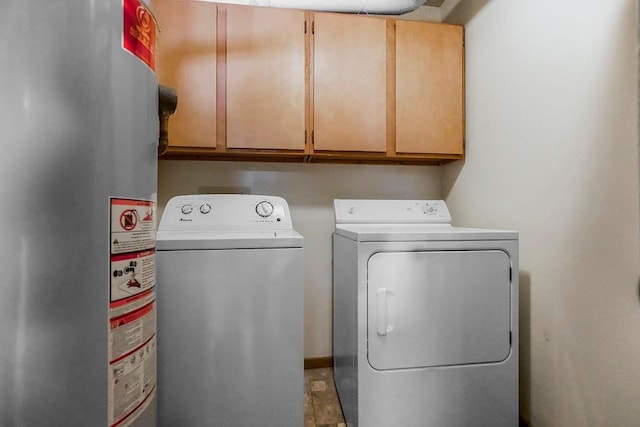 1339 Westbrooke St, Lawrence, KS 66049 - washroom with gas water heater, cabinet space, and washing machine and dryer