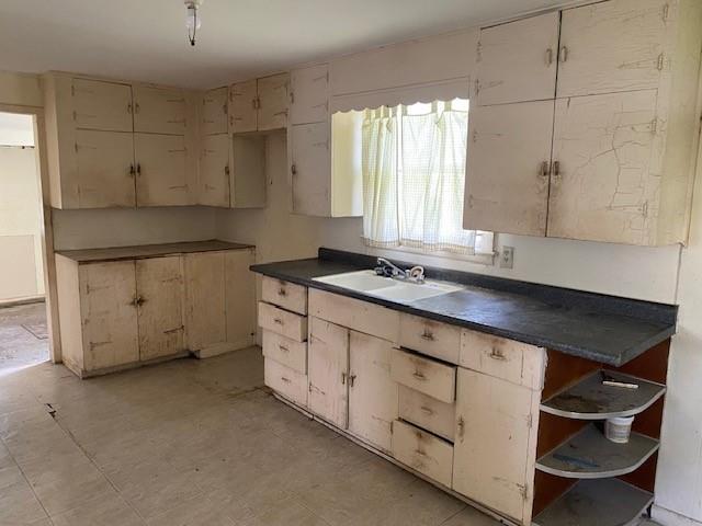 1209 S 6th St, Atchison, KS 66002 - kitchen with a sink, open shelves, and dark countertops