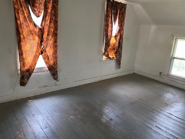 1209 S 6th St, Atchison, KS 66002 - bonus room with wood-type flooring, vaulted ceiling, and baseboards