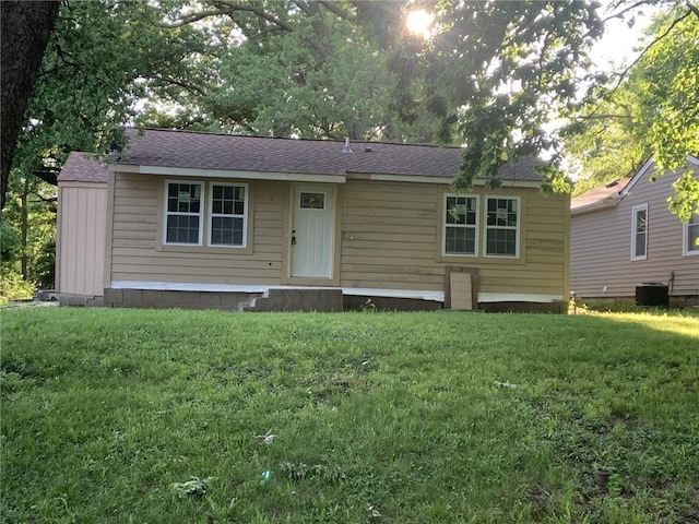 1424 S Liberty St, Independence, MO 64055 - view of front facade featuring a front lawn, central AC, roof with shingles, and entry steps