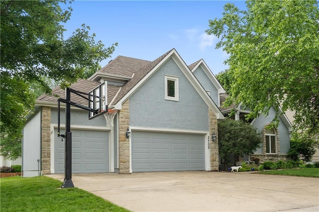 2705 W 137th Pl, Leawood, KS 66224 - view of property exterior with stone siding, concrete driveway, stucco siding, and a shingled roof