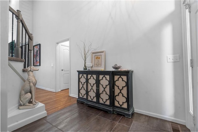 2705 W 137th Pl, Leawood, KS 66224 - hallway featuring stairway, baseboards, dark wood finished floors, and a high ceiling