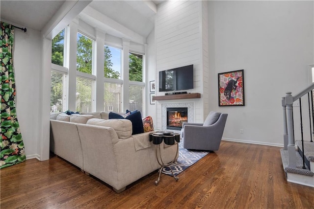 2705 W 137th Pl, Leawood, KS 66224 - living room with a large fireplace, a high ceiling, wood finished floors, baseboards, and stairway