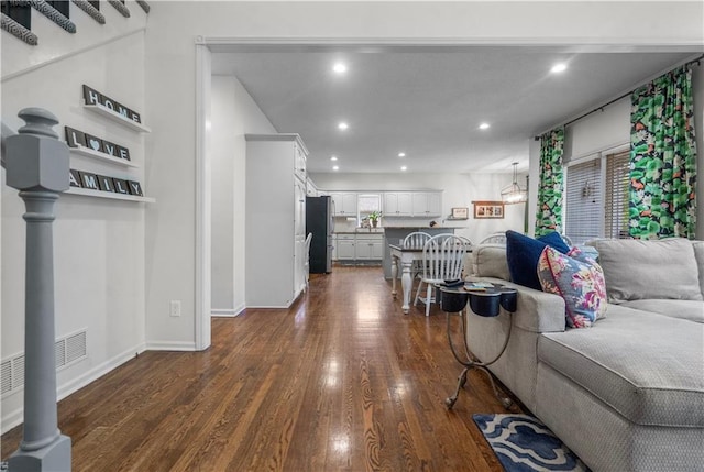 2705 W 137th Pl, Leawood, KS 66224 - living area with dark wood-style floors, recessed lighting, and baseboards