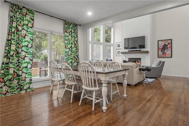 2705 W 137th Pl, Leawood, KS 66224 - dining space with a glass covered fireplace, baseboards, wood finished floors, plenty of natural light, and recessed lighting