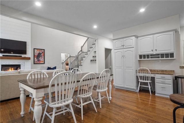 2705 W 137th Pl, Leawood, KS 66224 - dining space featuring dark wood finished floors, stairway, a large fireplace, and recessed lighting
