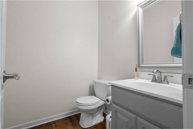 2705 W 137th Pl, Leawood, KS 66224 - bathroom featuring toilet, wood finished floors, vanity, and baseboards