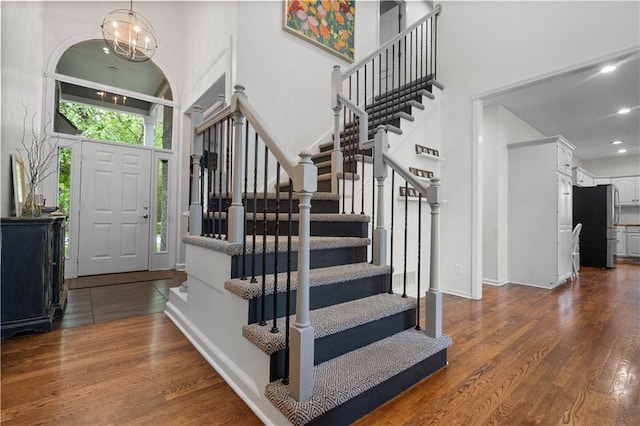 2705 W 137th Pl, Leawood, KS 66224 - entrance foyer featuring stairway, a towering ceiling, dark wood finished floors, a chandelier, and recessed lighting