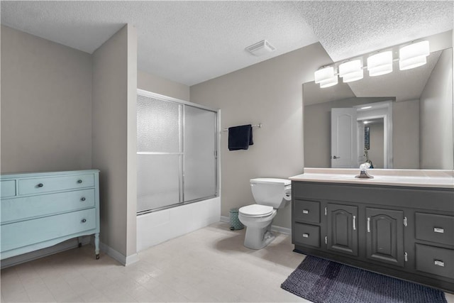 2705 W 137th Pl, Leawood, KS 66224 - bathroom with toilet, vanity, combined bath / shower with glass door, a textured ceiling, and baseboards