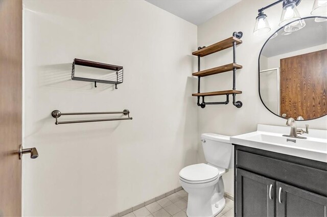 200 Main St Unit 211, Kansas City, MO 64105 - bathroom featuring vanity, toilet, baseboards, tile patterned flooring, and curtained shower