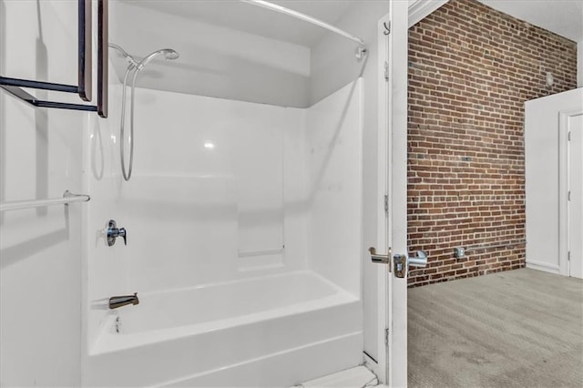 200 Main St Unit 211, Kansas City, MO 64105 - bathroom featuring brick wall and shower / bathtub combination