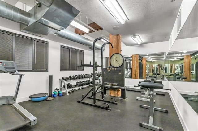 200 Main St Unit 211, Kansas City, MO 64105 - exercise room featuring baseboards and a textured ceiling