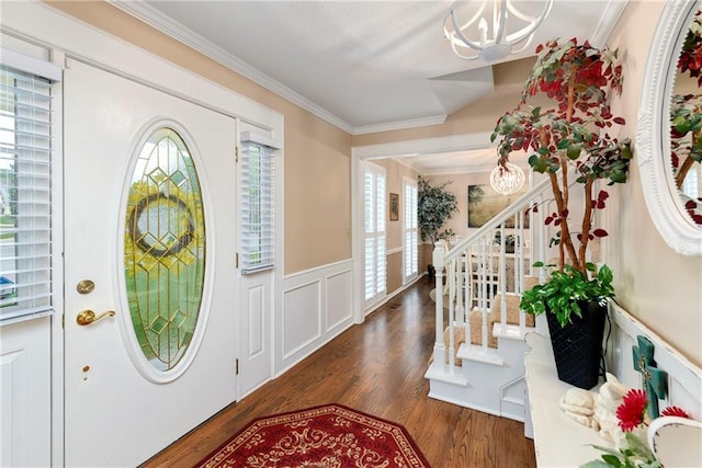10500 Reeder St, Overland Park, KS 66214 - entryway featuring stairs, wood finished floors, crown molding, wainscoting, and a chandelier