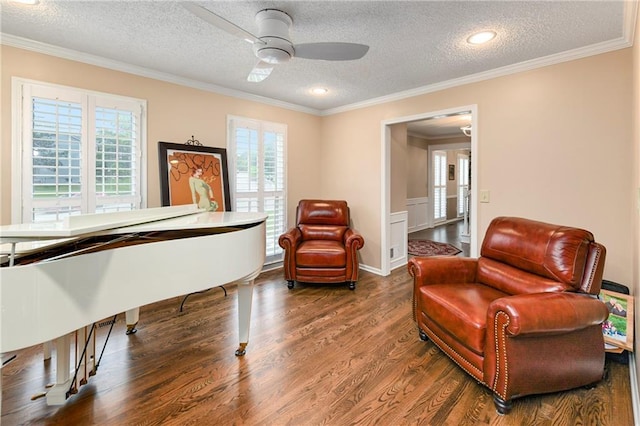 10500 Reeder St, Overland Park, KS 66214 - living area featuring a textured ceiling, dark wood-style flooring, crown molding, a ceiling fan, and wainscoting