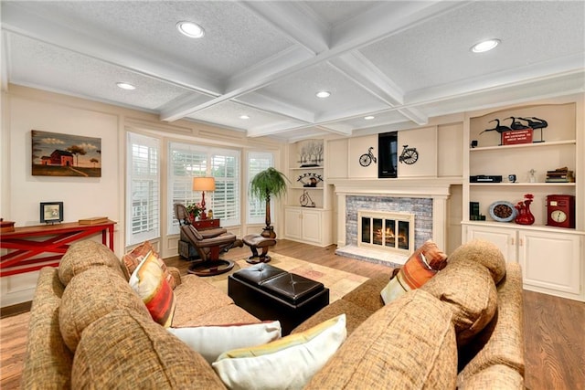 10500 Reeder St, Overland Park, KS 66214 - living room featuring wood finished floors, beamed ceiling, recessed lighting, a stone fireplace, and coffered ceiling