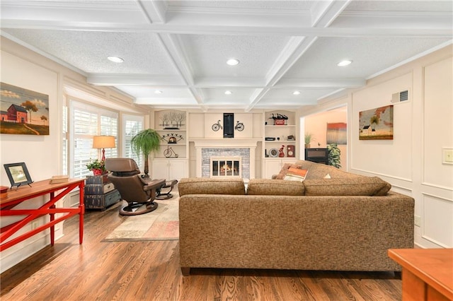 10500 Reeder St, Overland Park, KS 66214 - living room with recessed lighting, wood finished floors, a glass covered fireplace, beam ceiling, and coffered ceiling