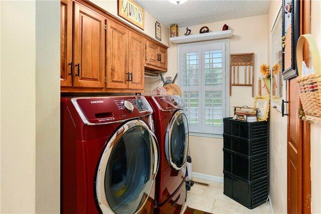 10500 Reeder St, Overland Park, KS 66214 - washroom with washing machine and dryer, healthy amount of natural light, cabinet space, a textured ceiling, and baseboards