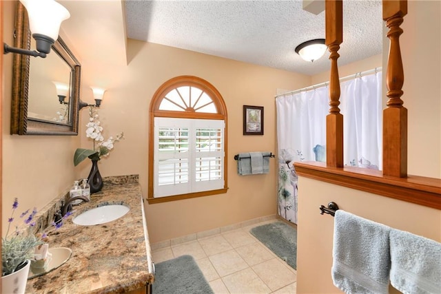 10500 Reeder St, Overland Park, KS 66214 - full bathroom featuring vanity, a textured ceiling, tile patterned floors, and a shower with shower curtain