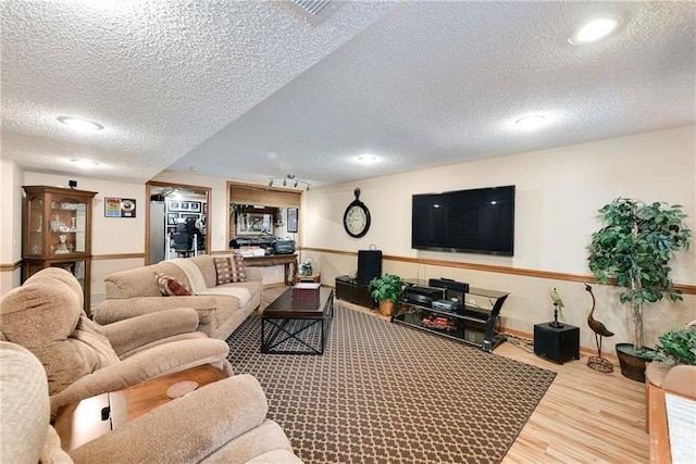 10500 Reeder St, Overland Park, KS 66214 - living area featuring a textured ceiling, wood finished floors, baseboards, and recessed lighting