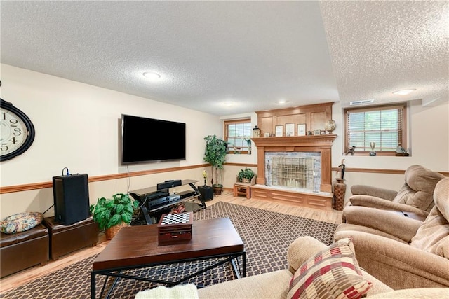 10500 Reeder St, Overland Park, KS 66214 - living area with a textured ceiling, a fireplace, and wood finished floors