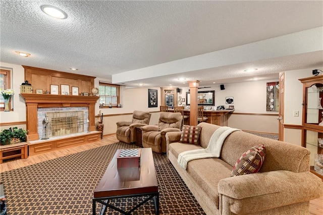 10500 Reeder St, Overland Park, KS 66214 - living area with a textured ceiling, recessed lighting, decorative columns, and wood finished floors