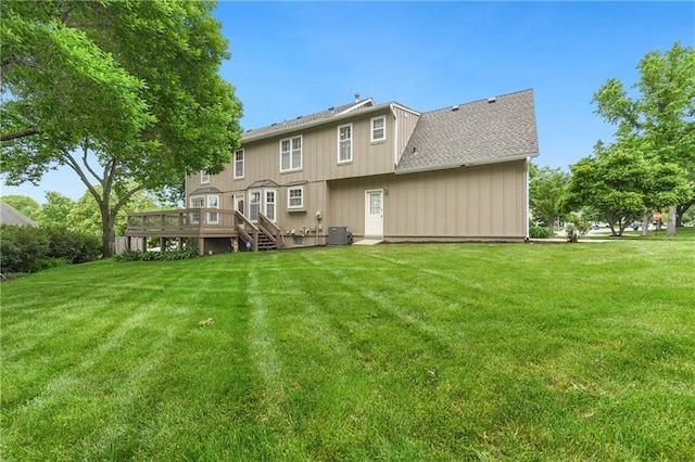 10500 Reeder St, Overland Park, KS 66214 - rear view of house with central AC, a deck, a yard, and a shingled roof