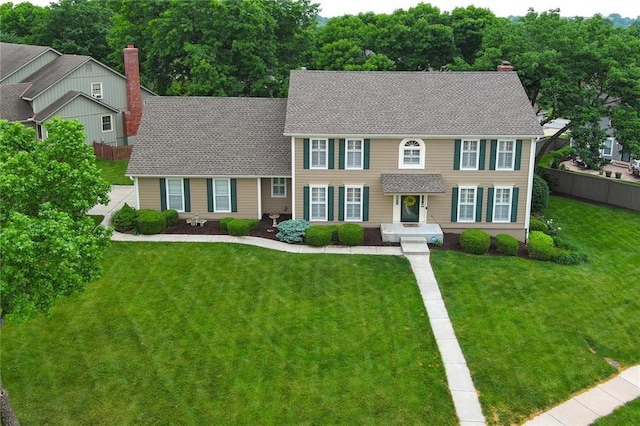 10500 Reeder St, Overland Park, KS 66214 - colonial inspired home featuring a chimney and a shingled roof