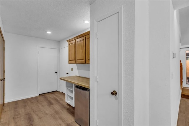 1528 E 123rd St, Olathe, KS 66061 - kitchen with fridge, light wood-type flooring, a textured ceiling, recessed lighting, and butcher block counters