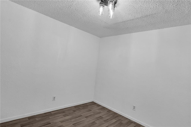 1528 E 123rd St, Olathe, KS 66061 - unfurnished room with wood finished floors, a textured ceiling, and baseboards