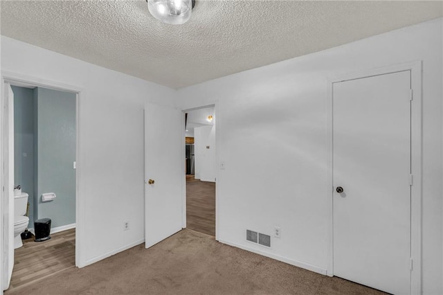 1528 E 123rd St, Olathe, KS 66061 - unfurnished bedroom with carpet flooring, a textured ceiling, and baseboards