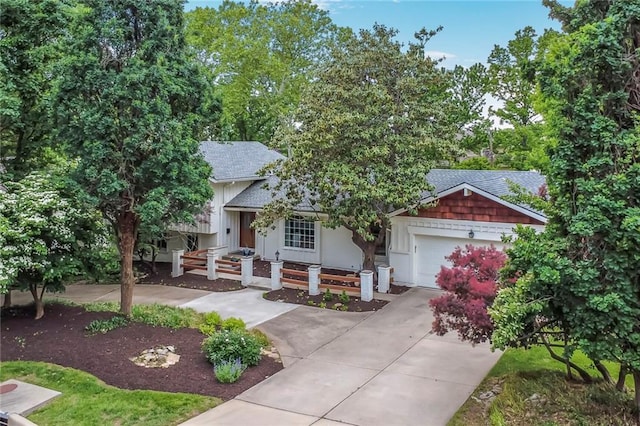 10416 Mohawk Ln, Leawood, KS 66206 - view of front of property with concrete driveway, a garage, roof with shingles, and covered porch