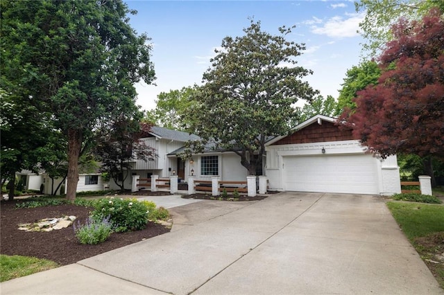 10416 Mohawk Ln, Leawood, KS 66206 - split level home with an attached garage and concrete driveway