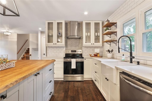 10416 Mohawk Ln, Leawood, KS 66206 - kitchen featuring wall chimney exhaust hood, stainless steel appliances, dark wood-style floors, backsplash, and recessed lighting