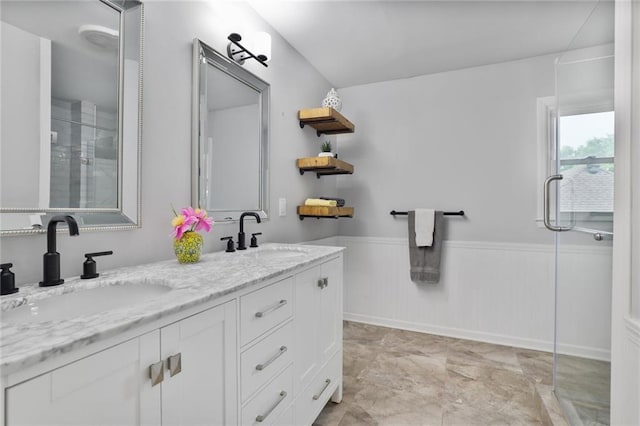 10416 Mohawk Ln, Leawood, KS 66206 - bathroom featuring a shower with shower door, a wainscoted wall, and double vanity