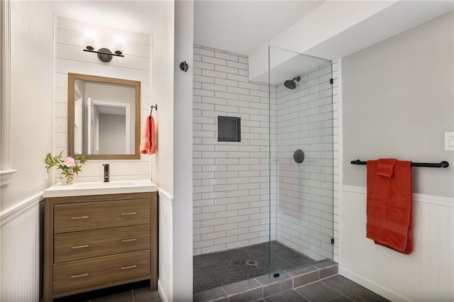 10416 Mohawk Ln, Leawood, KS 66206 - bathroom featuring tiled shower, vanity, and a wainscoted wall