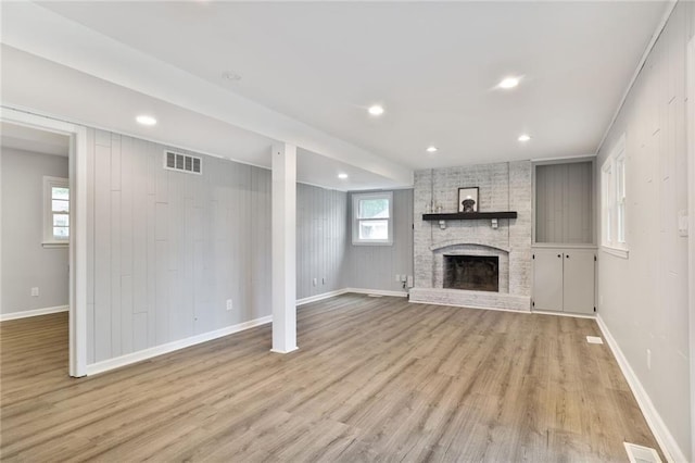 10416 Mohawk Ln, Leawood, KS 66206 - unfurnished living room with light wood-style floors, a fireplace, plenty of natural light, baseboards, and recessed lighting