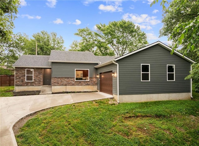 131 Cedar Ct, Warrensburg, MO 64093 - view of front of home featuring an attached garage, a front lawn, and concrete driveway