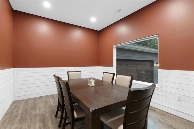 131 Cedar Ct, Warrensburg, MO 64093 - dining space with wainscoting, wood finished floors, wood walls, and recessed lighting