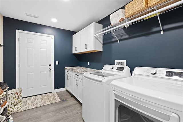 131 Cedar Ct, Warrensburg, MO 64093 - laundry area featuring independent washer and dryer, light wood-type flooring, cabinet space, baseboards, and recessed lighting