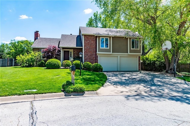 3515 Riverview Ct, Lawrence, KS 66049 - view of front of property featuring an attached garage, brick siding, concrete driveway, and a chimney