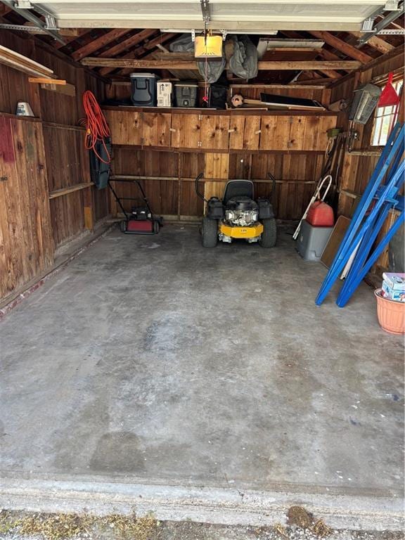 620 S Evergreen Ave, Chanute, KS 66720 - garage with a garage door opener and wooden walls