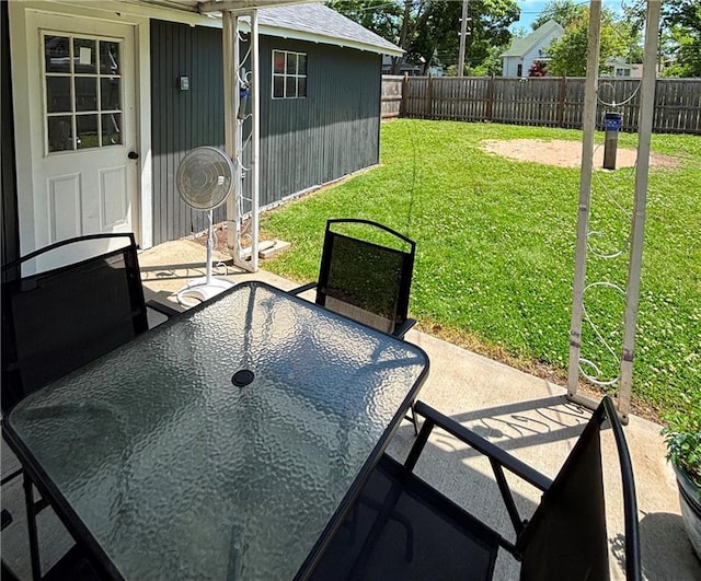 620 S Evergreen Ave, Chanute, KS 66720 - view of patio with outdoor dining area and an outbuilding