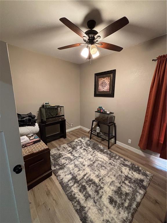 620 S Evergreen Ave, Chanute, KS 66720 - home office with a ceiling fan, light wood-type flooring, and baseboards