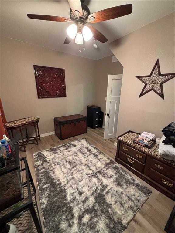 620 S Evergreen Ave, Chanute, KS 66720 - bedroom with light wood-style floors, a ceiling fan, and baseboards