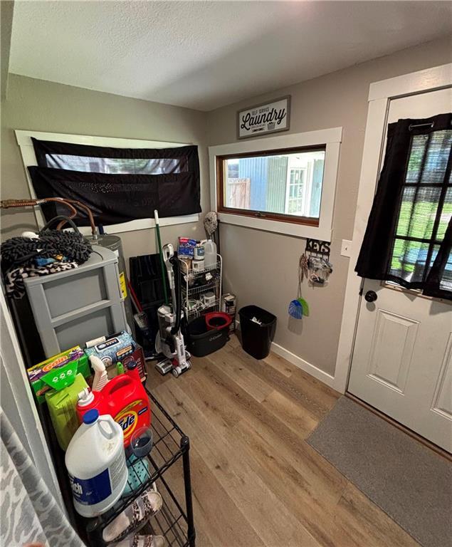 620 S Evergreen Ave, Chanute, KS 66720 - entryway with wood finished floors, baseboards, and a textured ceiling