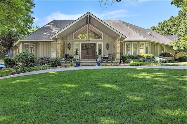 8201 W 100th Ter, Overland Park, KS 66212 - view of front of house featuring stone siding, a front yard, board and batten siding, and a shingled roof