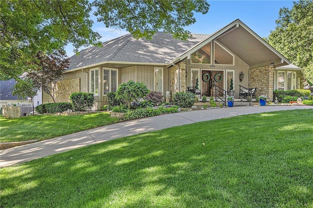 8201 W 100th Ter, Overland Park, KS 66212 - view of front of property with stone siding, a front lawn, and a shingled roof