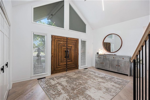 8201 W 100th Ter, Overland Park, KS 66212 - foyer featuring high vaulted ceiling, wood finished floors, beamed ceiling, and baseboards
