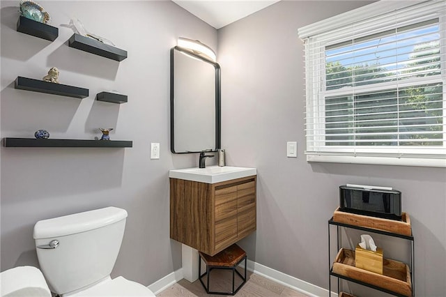 8201 W 100th Ter, Overland Park, KS 66212 - bathroom with toilet, baseboards, and vanity